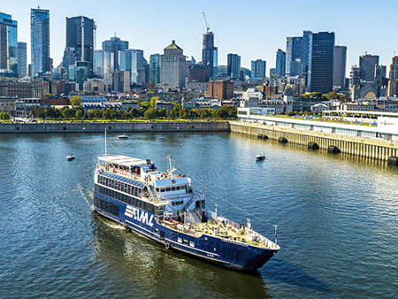 The AML Cavalier Maxim ship leaving the Old Port of Montreal with a clear view of the city skyline