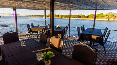 Salle intérieure avec des tables avec la vue sur le Saint-Laurent