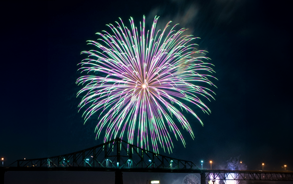 Gros feux d'artifice époustouflant bleu et rose à Montréal avec l'ombre du pont Jacques Cartier en-dessous