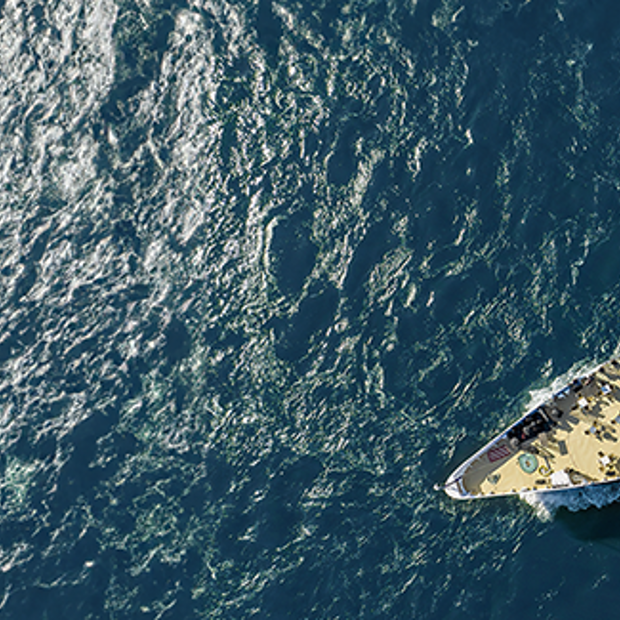  Aerial view of the AML Cavalier Maxim ship sailing to the right on the Saint Lawrence River in Montreal.