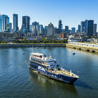 The AML Cavalier Maxim ship leaving the Old Port of Montreal with a clear view of the city skyline