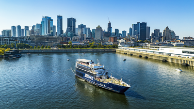 The AML Cavalier Maxim ship leaving the Old Port of Montreal with a clear view of the city skyline