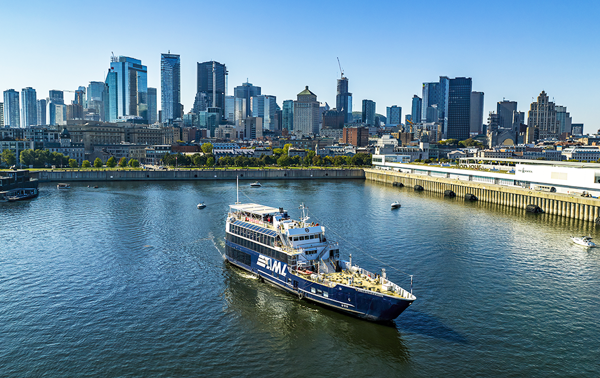 The AML Cavalier Maxim ship leaving the Old Port of Montreal with a clear view of the city skyline