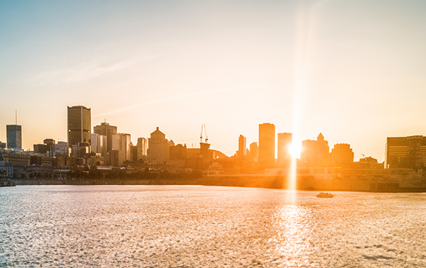 A sunset casting a warm glow on the skyline of Montreal.