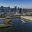 Vue aérienne du navire AML Cavalier Maxim sortant du Vieux Port de Montréal avec une vue sur la ville en arrière plan sous un ciel bleu