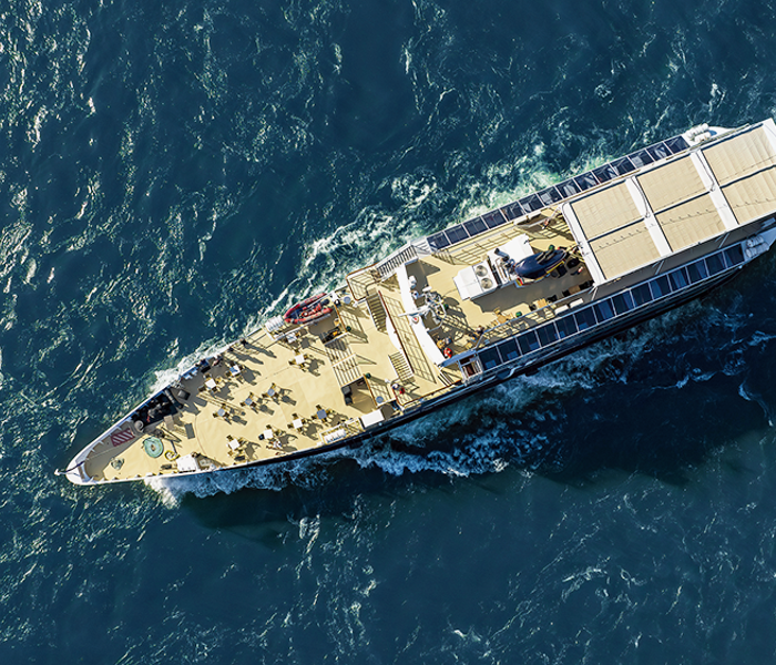 Close-up aerial view of the AML Cavalier Maxim sailing on the St. Lawrence River in Montreal.