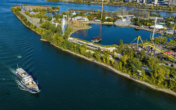 Aerial view of the AML Cavalier Maxim sailing past La Ronde in Montreal by day.