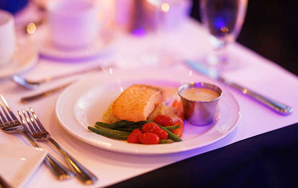 A well-presented plate of salmon accompanied by a portion of fresh market vegetables.